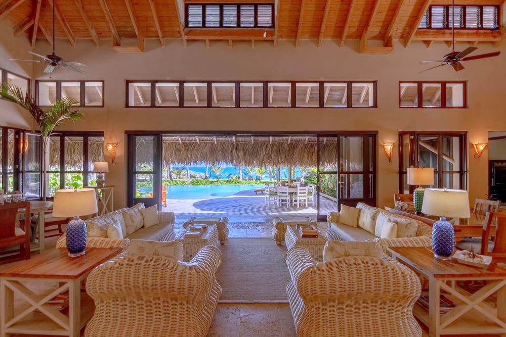 Living room opening onto the pool through wide sliding doors