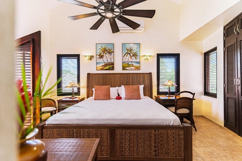 Bedroom with rattan bed and palm tree artwork