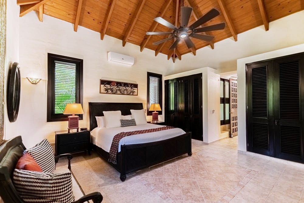 Suite with king bed and wooden ceiling
