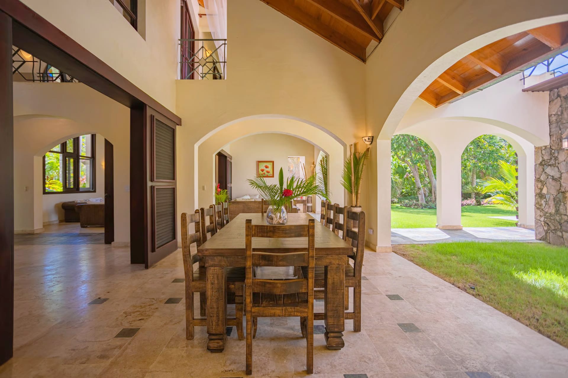 Covered dining terrace under stone arches