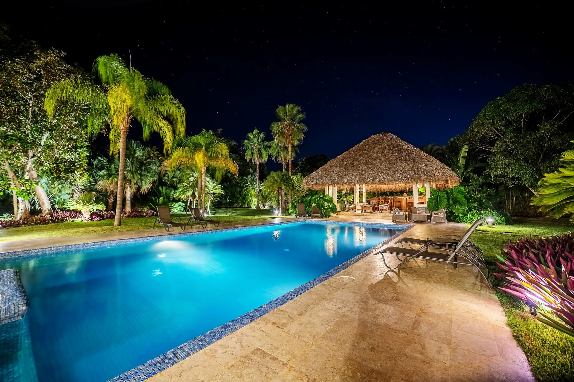 Pool and gazebo lit up at night