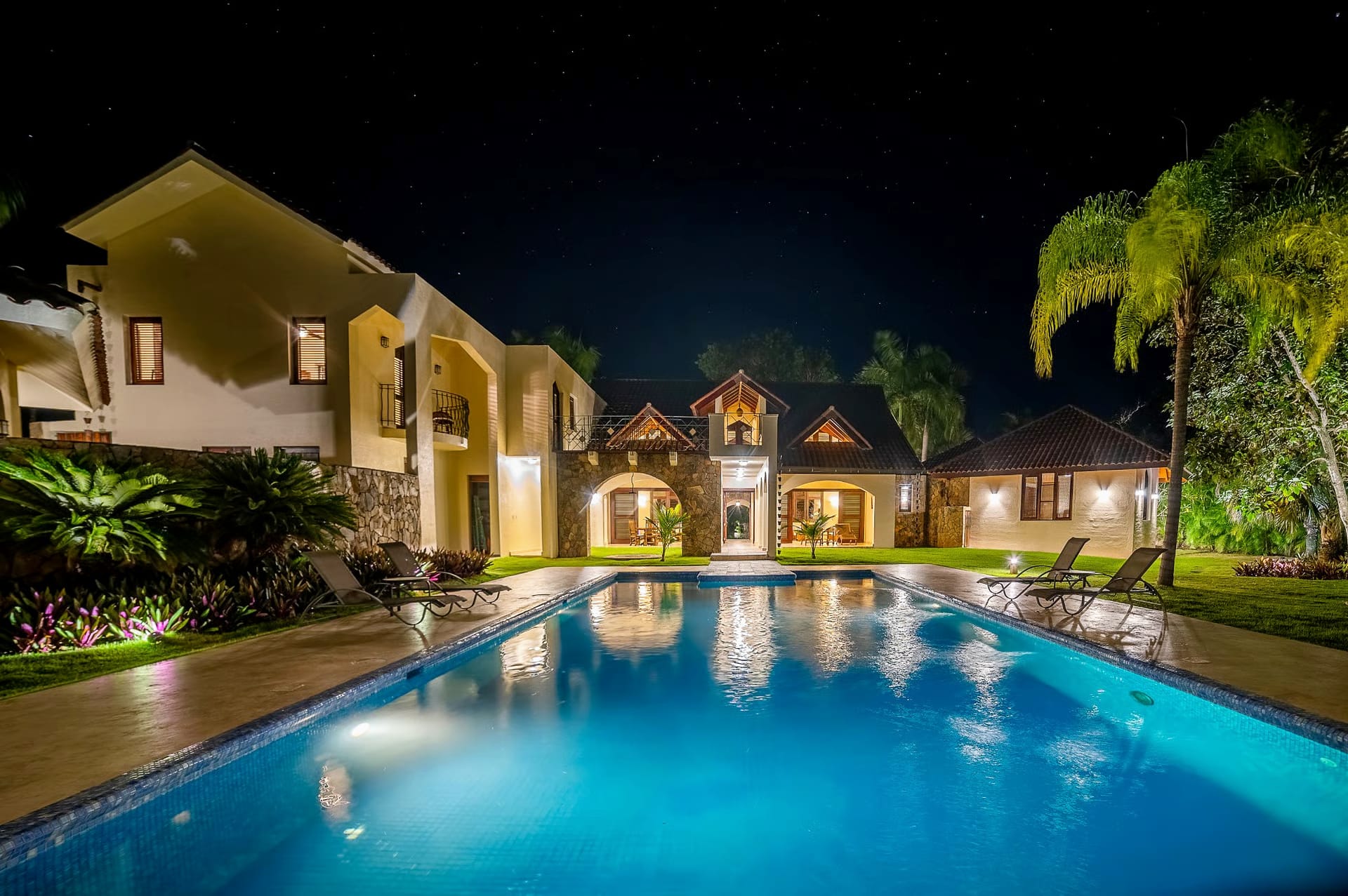 Villa and pool lit up at night