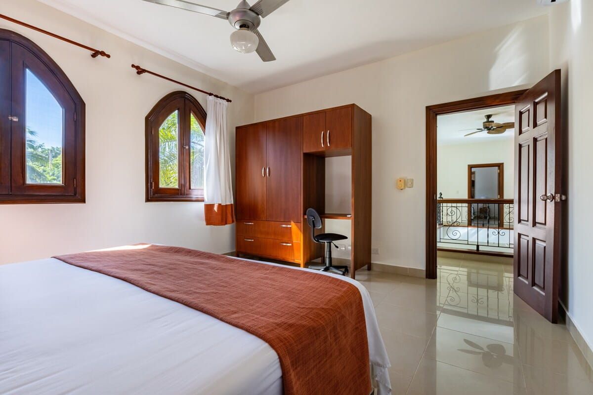 Bedroom with arched windows and wardrobe
