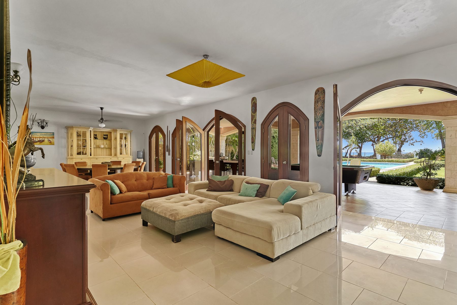 Living room with sofas facing the pool terrace