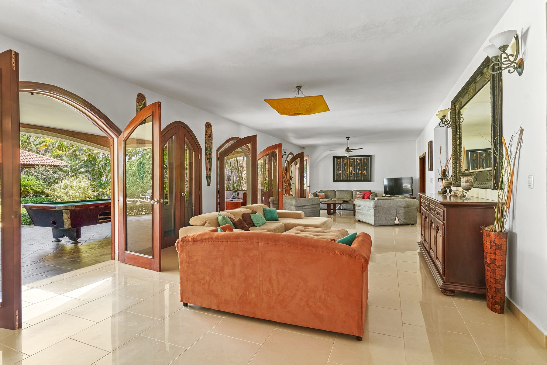 Open living spaces with arched doors to the gardens