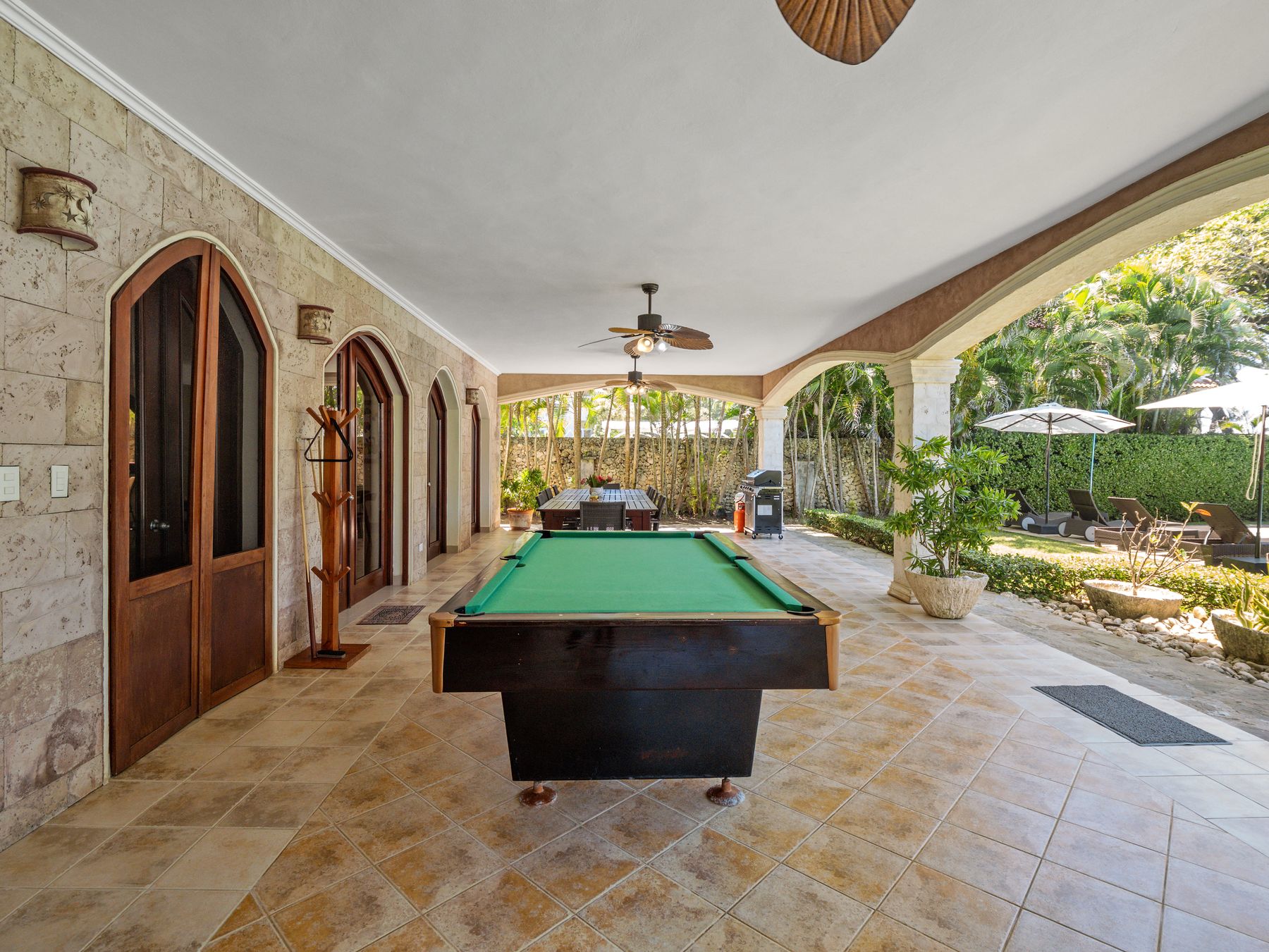 Outdoor lounge with billiard table next to the pool